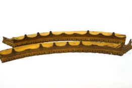 A 19th century gesso and gilt shaped wood cornice pelmet in two pieces,