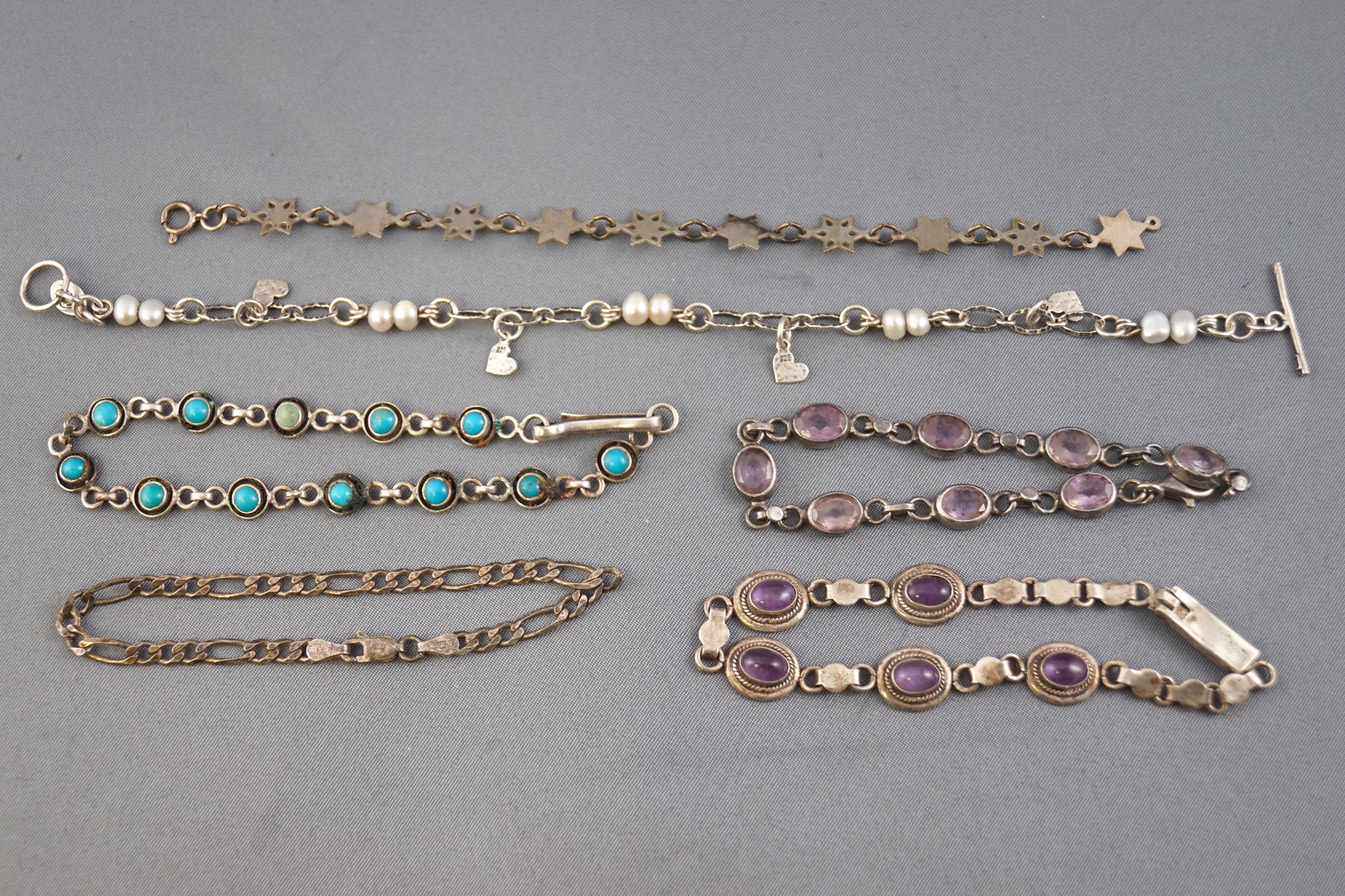 A collection of six silver bracelets of variable designs.