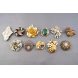 A collection of twenty costume brooches of variable designs.