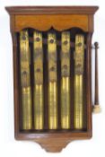 An oak cased five note brass glockenspiel style dinner gong,