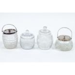Four clear cut-glass biscuit barrels, two with plated collars and covers,
