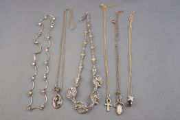 A collection of jewellery to include three silver necklaces,