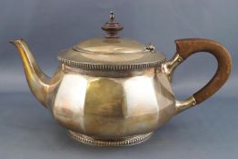 A silver three piece tea service of rounded panelled form,