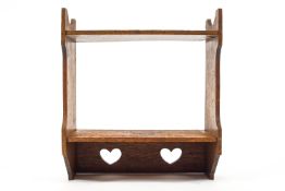 A set of wall shelves with cut out love hearts in the style of Voysey,