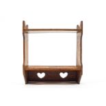 A set of wall shelves with cut out love hearts in the style of Voysey,