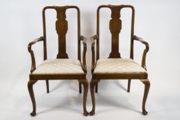 A pair of mahogany elbow chairs with vase shaped splats