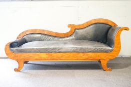 A Biedermier Recamier Karellan Birch and leather sofa with shaped back and scroll ends