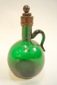 A 19th century green glass decanter with brass mounts,