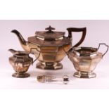 A silver three piece tea service of flared octagonal form,