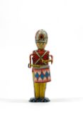 A polychrome transfer decorated clockwork tin plate drummer boy toy soldier,