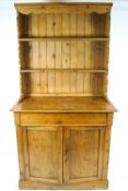 A Victorian pine two shelf dresser, the base with a long drawer over a two door cupboard,