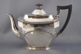 A silver three piece tea service of cut cornered rectangular form with plain domed lid