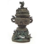 A Japanese bronze censor on a stand decorated with prunus blossom,