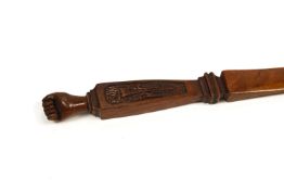 A Royal flying Corps carved mahogany letter opener, with a clenched hand finial,