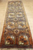 A large rug on a brown field, set with ten quartered panels in rust and cream,