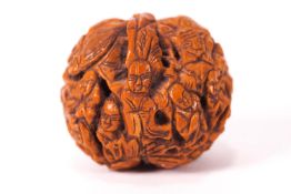 A Chinese carved walnut, decorated with figures and tigers in a rocky landscape,