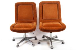 Two corduroy chairs (NB to be sold as a collectors item only), on five splay metal swivel stands,