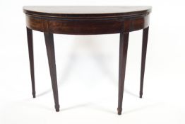 An 18th century mahogany Hepplewhite demi-lune tea table with plain frieze