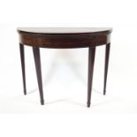 An 18th century mahogany Hepplewhite demi-lune tea table with plain frieze