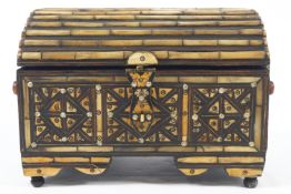 A Middle Eastern casket of domed top form inlaid/set with bone and brass ribbing and wire,