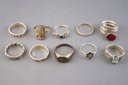 A collection of ten silver dress rings of variable designs. Size range from K to S.