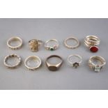 A collection of ten silver dress rings of variable designs. Size range from K to S.