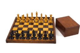 A weighted Staunton chess set and board, the white wood knight and castle stamped with a red crown,