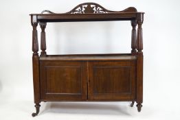 A 19th century oak buffet with pierced shaped crest reeded uprights above two doors,