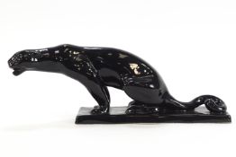 A slip cast pottery figure of a black panther on rectangular base,