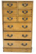 A pine chest of six short drawers above three long drawers with swing handles,