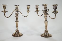 A pair of silver plated candelabra, each with detachable sconces,