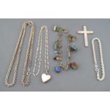 A collection of silver jewellery to include a large engraved cross pendant, a rope bracelet,