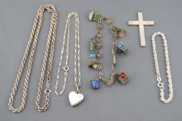 A collection of silver jewellery to include a large engraved cross pendant, a rope bracelet,