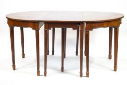 A mahogany 'D' end dining table, with reeded tapering legs,