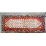 A large wool carpet of Middle Eastern runner design,