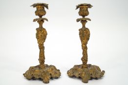 A pair of 18th century style cast metal candlesticks, later gold painted,