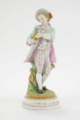 A French bisque figure of a gentleman holding a potted rose, impressed AM to base,