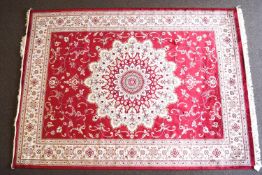 A red ground Keshan carpet,