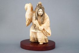 An early 20th century ivory netsuke of an actor with revolving mask, signed to the base,