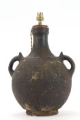 A two handled terracotta vase converted to a table lamp,