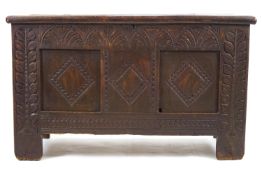 An early 18th century style mixed elm and other wood chest with plain rectangular top,