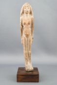 An Egyptian terracotta Shabti tomb figure of a naked female wearing a braided head piece, 14cm high,