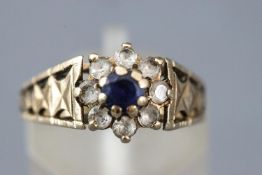 A yellow metal cluster ring set with blue and white sapphires (stones untested).