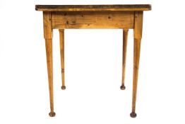 A square pine table on turned tapering legs with flared feet,