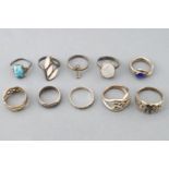 A collection of ten silver rings of variable designs. Size range from L to R.