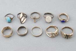 A collection of ten silver rings of variable designs. Size range from L to R.