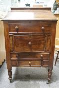 A Victorian and later mahogany clerk's desk on turned legs with brass and ceramic casters,