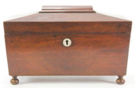 A Victorian mahogany tea caddy, of sarcophagus form (lacking mixing bowl) on turned feet,