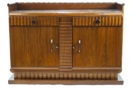 An Art Deco style walnut sideboard with bamboo style back rail over a flat top with curved edge,