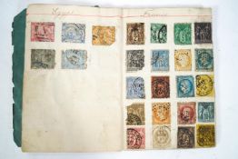 A Victorian stamp album containing World stamps,